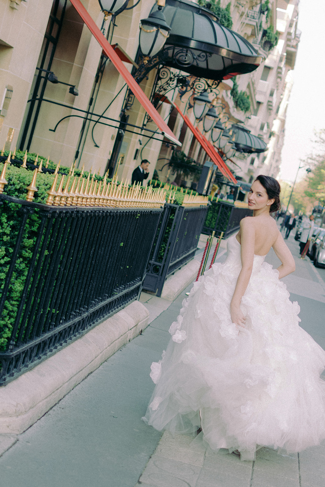 Bride walking outside Plaza Athénée on Avenue Montaigne